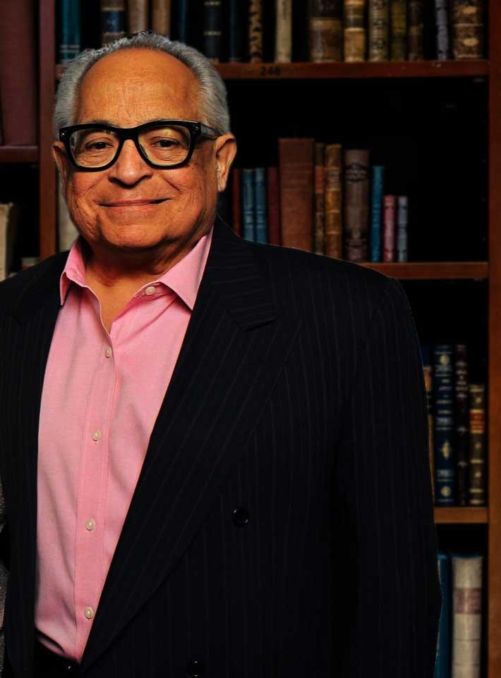 Carlos A. Martir, Jr., Esq., criminal defense attorney, photographed in his law library